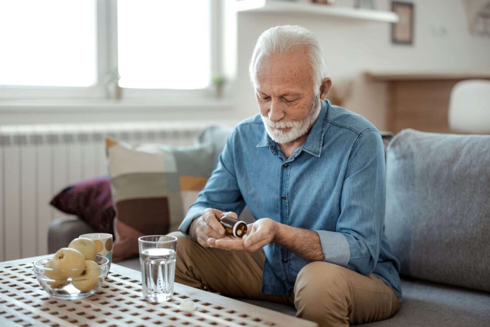 Senior male taking medication