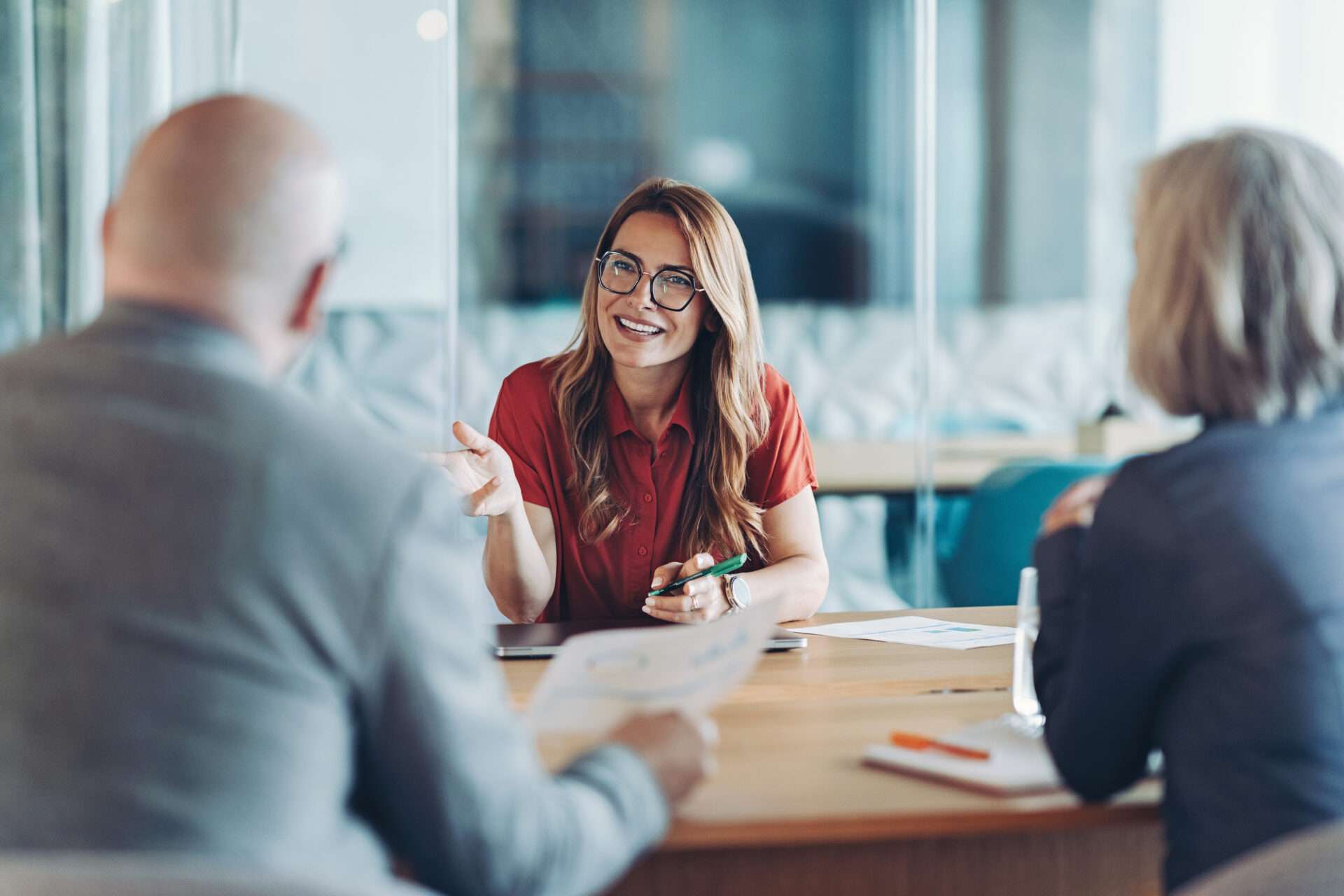 Operational excellence Young woman leader with glasses meeting with clients