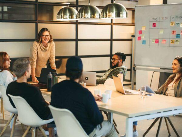 Colleagues at work around a white board