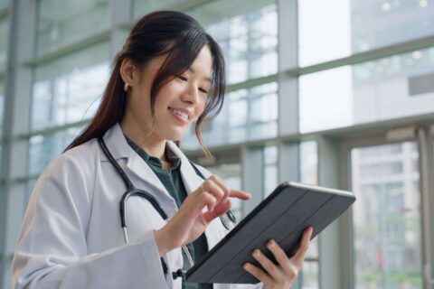 Newsroom Doctor using tablet in hospital