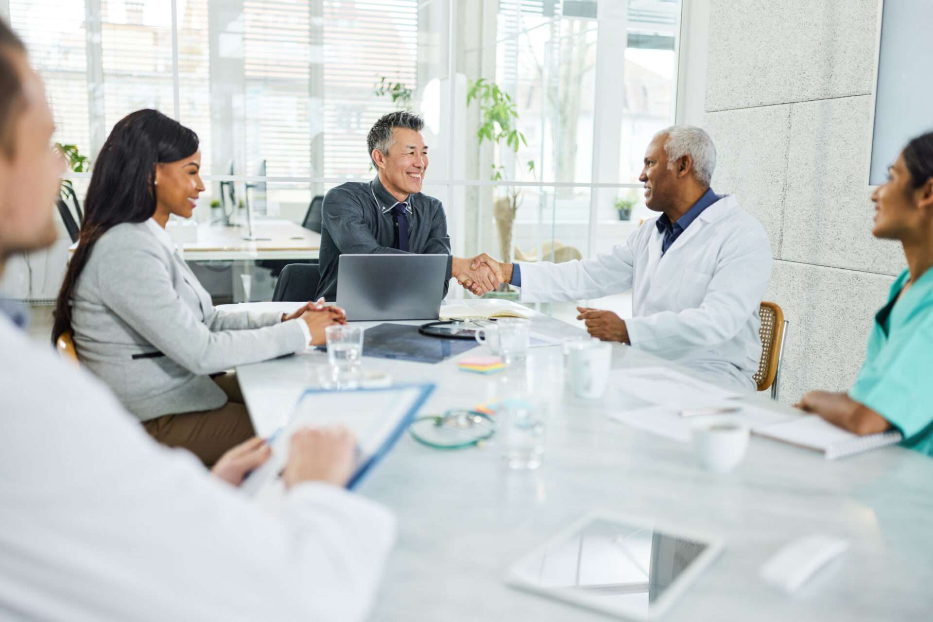 Doctors shaking hands at hospital meeting